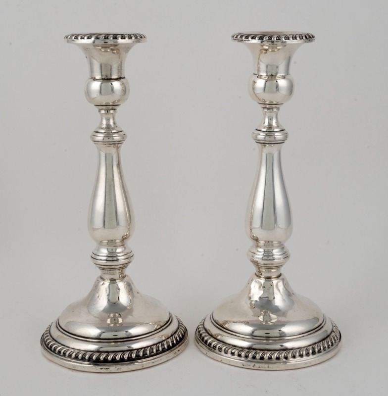 A pair of sterling silver Georgian style candlesticks with weighted bases, by Frank M. Whiting, 29th century,  ​​​​​​​23.5cm high 