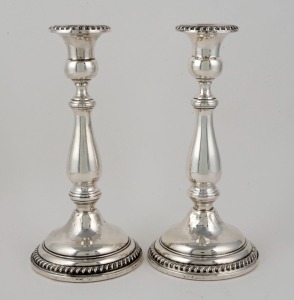 A pair of sterling silver Georgian style candlesticks with weighted bases, by Frank M. Whiting, 29th century,  ​​​​​​​23.5cm high 