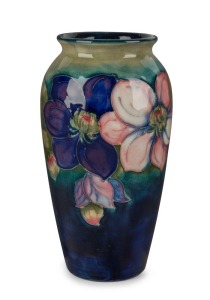MOORCROFT "Clematis" English pottery vase on blue and celadon ground, impressed signature and mark "W. Moorcroft Potter to H.M. The Queen, Made in England", 19cm high