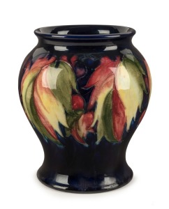 MOORCROFT "Berries" English pottery vase with blue ground,  impressed signature and mark "W. Moorcroft Potter to H.M. The Queen, Made in England",  16cm high 