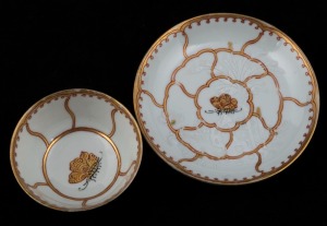An antique porcelain tea bowl and saucer with butterfly decoration, 18th century, the saucer 12cm diameter