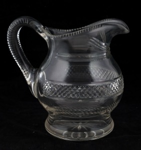 An antique Irish crystal jug, early to mid 19th century, 19cm high, 20cm wide