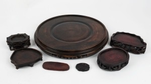 Seven assorted Chinese carved wooden stands, mixed vintages, ​​​​​​​the largest 27cm diameter