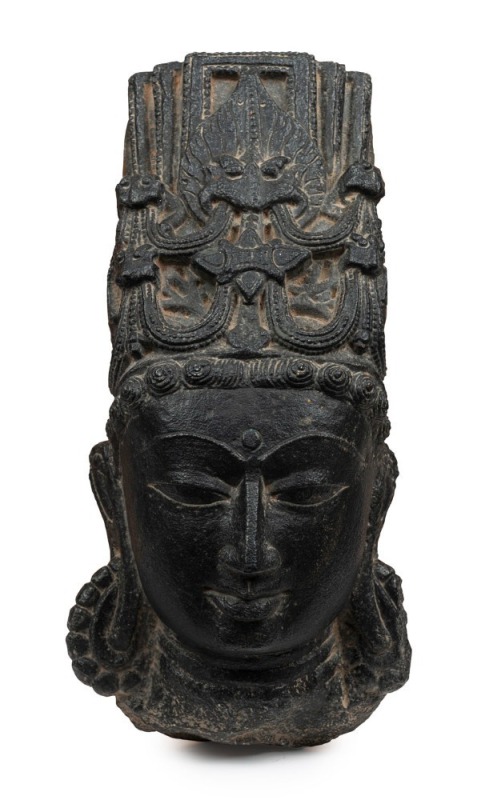 Head of a deity, carved black basalt, Indian origin, 14th century, ​​​​​​​37cm high