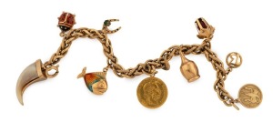 A vintage 18ct yellow gold charm bracelet and assorted gold charms, including an Austrian 10 Corona gold coin, gold mounted tiger claw, enamel beetle, etc, 28.7 grams total