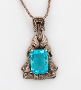 A vintage silver pendant, set with a cut blue topaz, suspended on a silver chain, early to mid 20th century, stamped "925", ​​​​​​​the pendant 4.7cm high, the chain 42cm long