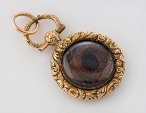An antique yellow gold and black enamel mourning pendant with hair lock window verso, 19th century, 3cm high overall