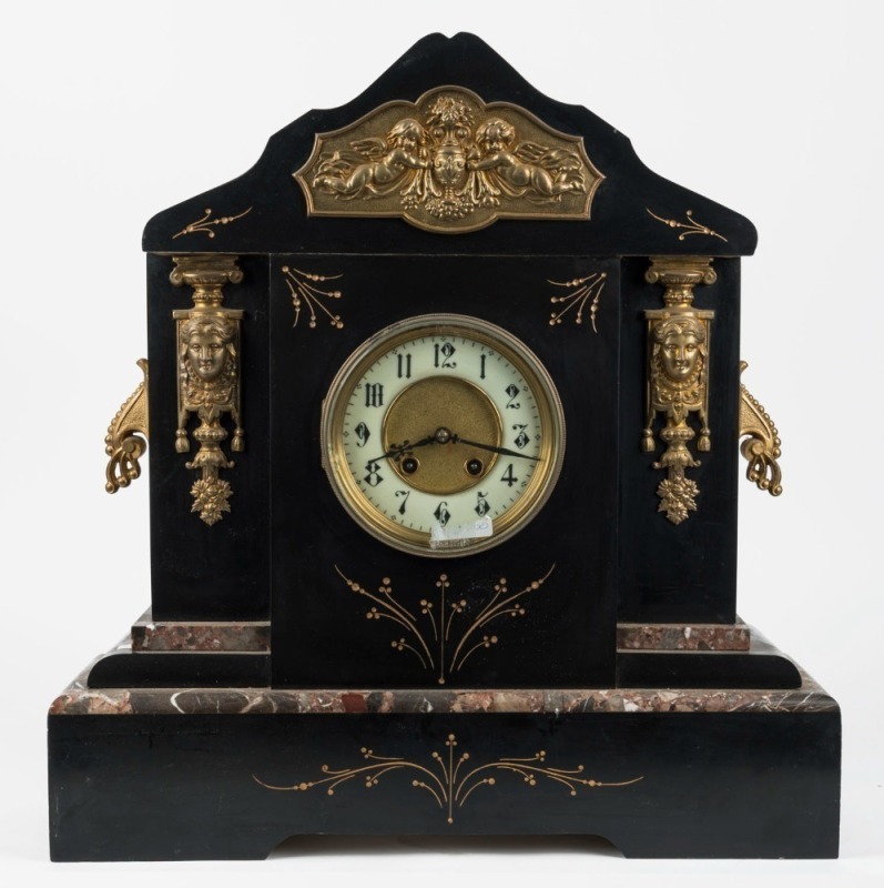 An antique H.A.C. American mantle clock in black slate case with 8 day time and strike movement with ormolu mounts and Arabic numerals, 19th century, ​​​​​​​50cm high, 48cm wide