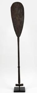 A ceremonial paddle carved wood, Borneo origins,  with accompanying stand,  ​​​​​​​110cm high 