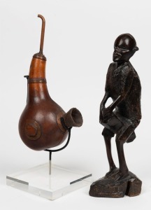 A tribal pipe gourd, timber, copper, Congo origin,  with accompanying stand, together with an African carved wooden statue,  21 and 25cm high 