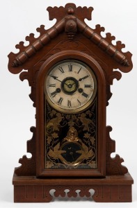 An antique American kitchen clock, carved walnut case with time, strike and alarm movement, circa 1890, 48cm high