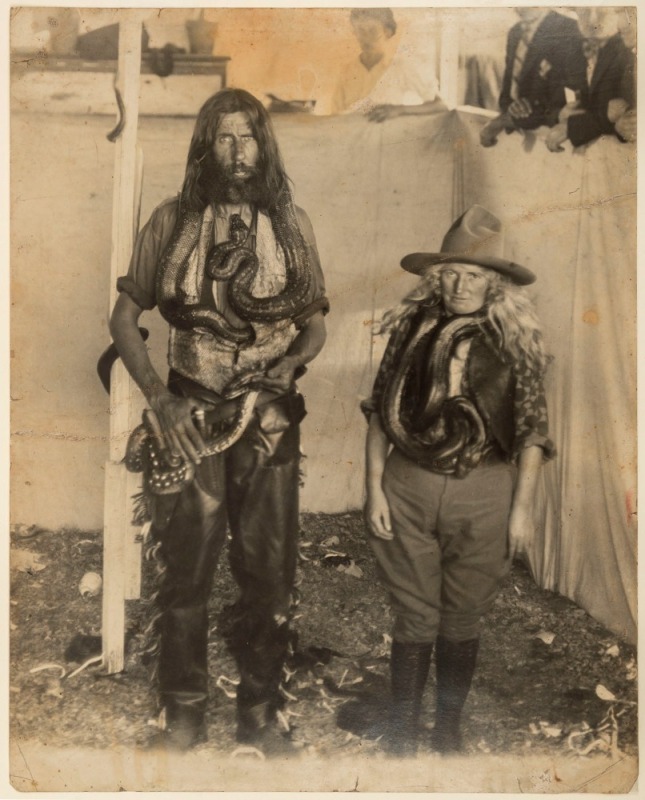 Unknown Photographer, Male and female rattlesnake sideshow performers, photographed within their tented enclosure, circa 1920, 40 x 31.5cm. Almost certainly "Wild West" snake charmers.