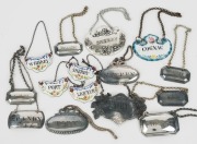 Decanter labels: collection of 15 including sterling silver, silver plate and enameled examples, 19th and 20th century,&nbsp; the largest 6cm wide