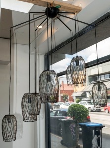 A modern eight shade spider hanging ceiling light, anodized steel frame with wire shades, 21st century