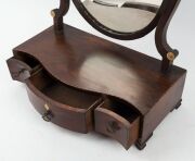 A Georgian mahogany oval toilet mirror with serpentine front, barber pole string inlay and whale bone roundels, late 18th century, 57cm high, 43cm wide, 21cm deep  - 2