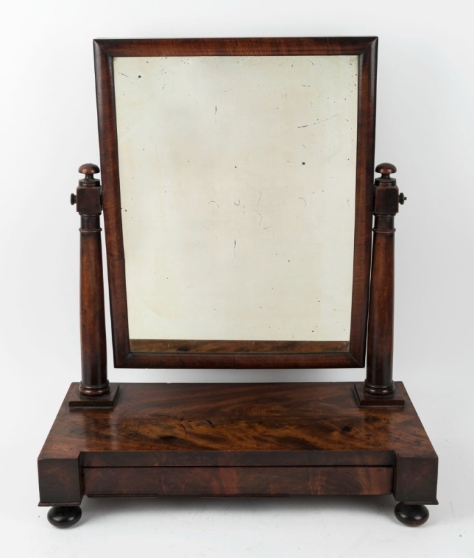 An antique English mahogany toilet mirror with inverted break front and cushion moulded mirror, mid 19th century, 61cm high, 52cm wide, 25cm deep