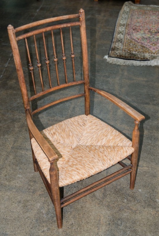 An antique English fireside chair with rush seat, 19th century, 85cm high, 49cm across the arms