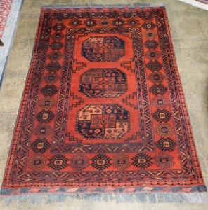 A Persian hand-knotted wool rug on burgundy and red ground, 153 x 102cm