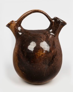 JOHN GILBERT brown glazed pottery jug. incised "Gilbert", 21.5cm high