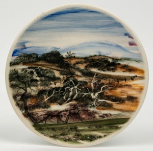 JOHN HOWLEY hand-painted pottery plaque with Australian landscape scene, ​​​​​​​18.5cm diameter