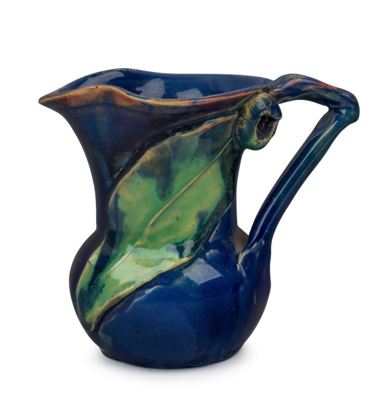 REMUED blue and green glazed pottery jug with applied gumnut and leaf, incised "Remued Hand Made", 11cm high