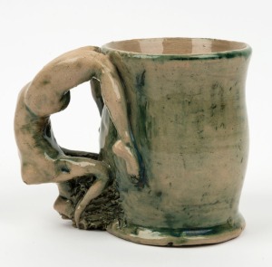 JUNE DYSON green glazed pottery mug with female nude handle, signed "Dyson", ​​​​​​​10cm high, 13cm wide