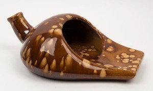 An Australian colonial pottery slipper pan with Rockingham glaze, 19th century, 38cm long