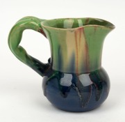 REMUED pottery jug with applied gumnuts, leaf and branch handle, glazed in early lime green, pink and blue, incised "Remued", 10.5cm high - 2