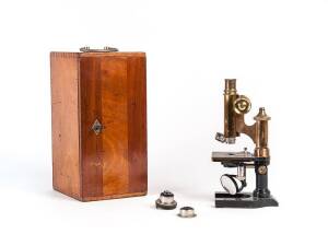 MICROSCOPE: Antique brass, housed in original timber case with 4 German lenses by Ernst Leitz & Carl Zeiss.