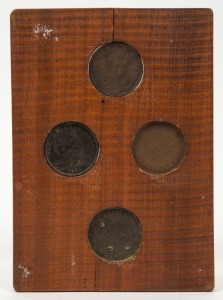 SHOP TOKENS. Group of four Australian examples mounted in fiddle back timber frame, 19th century,  17 x 12cm overall