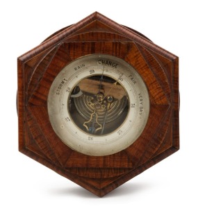 An antique aneroid wall barometer with exposed movement, in a fine fiddleback blackwood case, 19th century, 22cm high