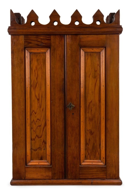 An antique Australian apprentice miniature linen press in the Gothic style, red pine and cedar with a crenelated cornice, South Australian origin, 19th century, 69cm high, 44cm wide, 25cm deep