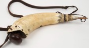 A scrimshaw powder horn adorned with tallships, later leather strapping, 35cm long - 2