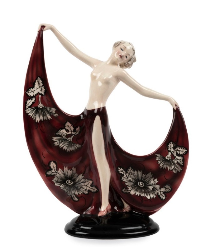 GOLDSCHEIDER Austrian porcelain statue of a lady in a burgundy skirt, signed "Lorenzl", black factory mark "Goldscheider, Wien, Made in Austria", 24cm high