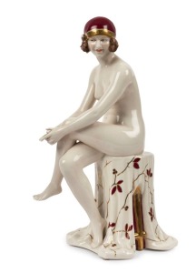 ROYAL DUX Czechoslovakian Art Deco porcelain statue of a seated nude in burgundy cap, pink triangle mark to base, 36cm high