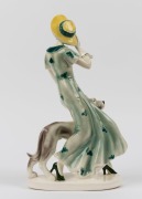 A Continental&nbsp;Art Deco porcelain statue of a lady in a green dress with hound, 38.5cm high - 2