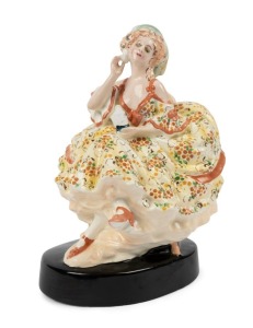 GOLDSCHEIDER Austrian porcelain statue of a seated lady in yellow dress, circa 1918, black factory mark "Goldscheider, Wien", with artist monogram "A. M.", 21cm high