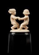 An Austrian Art Deco carved ivory figural group statue of dancing putti figures, mounted of faceted ebonised base, signed "S. W., 1931", 8cm high overall - 2