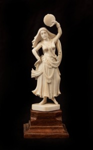 An Indian carved ivory statue of a dancing woman on timber plinth, early to mid 20th century, 18cm high