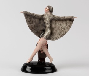 GOLDSCHEIDER Art Deco porcelain statue of a dancing lady in a grey floral gown and cap, black factory mark "Goldscheider, Wien, Made in Germany", 22cm high