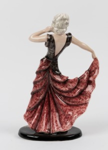 GOLDSCHEIDER Austrian Art Deco porcelain statue of a dancing woman in a burgundy ruffle dress, signed "Lorenzl", black factory mark "Goldscheider, Wien, Made in Austria" with original foil label, 30cm high