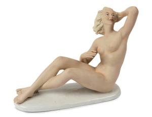 SCHAUBACH KUNST German Art Deco porcelain statue of a reclining female nude, green factory mark to base, 20.5cm high, 25cm long