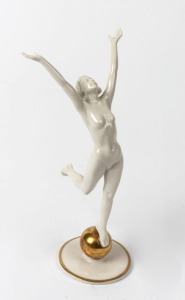 HUTSCHENREUTHER German Art Deco white porcelain statue of a lady standing on a gilded globe, signed "K. Tutter", blue factory mark to base with original paper label, 21.5cm high