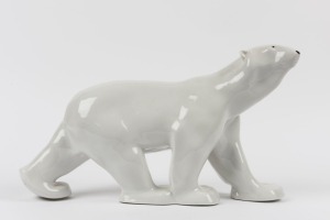 A Continental porcelain statue of a polar bear, marks illegible, 24cm high, 42cm long