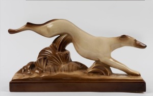 A Continental Art Deco statue of a greyhound, 24cm high, 46cm long