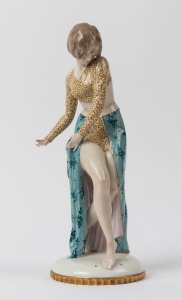 A German Art Deco porcelain statue of a lady in leopard print and green dress, green crown mark to base, 30.5cm high