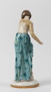 A German Art Deco porcelain statue of a lady in leopard print and green dress, green crown mark to base, 30.5cm high - 2