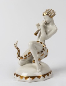 HUTSCHENREUTHER German white porcelain snake charmer statue with gilded highlights, green factory mark to base, impressed "K. Tutter", 14cm high