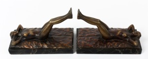 A pair of Art Deco figural bronze reclining nude bookends on black marble bases, 14cm high, 21cm long