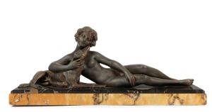 A French Art Deco spelter statue of a reclining female nude and dog on Sienna marble base, circa 1930, 23cm high, 54cm wide